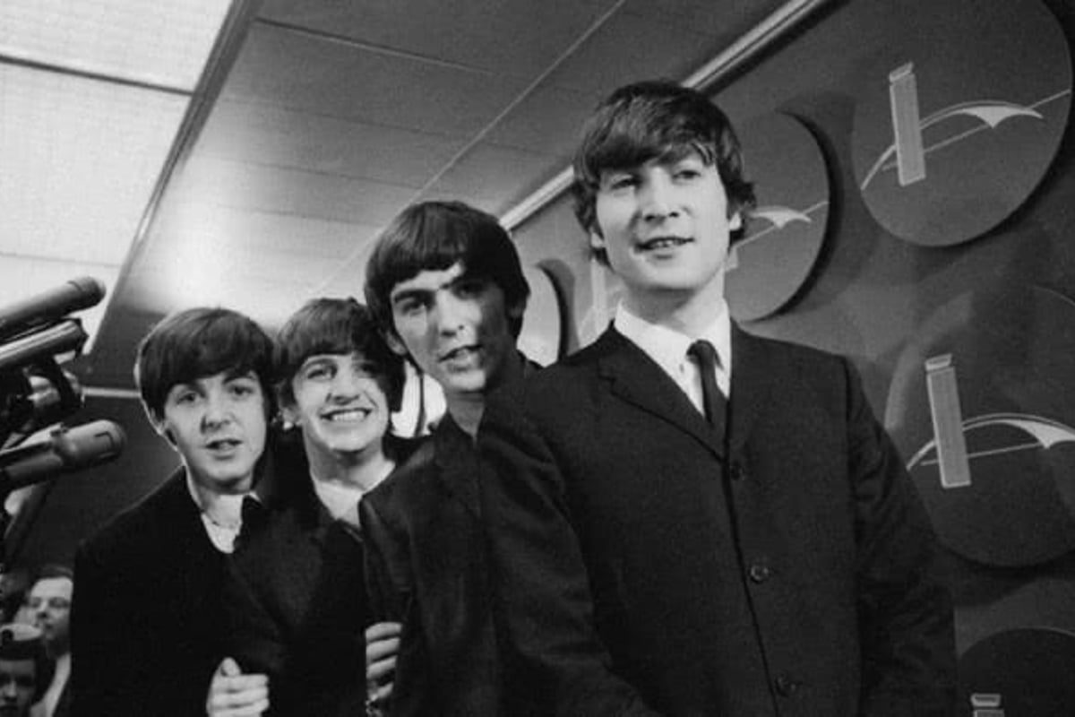A portfolio of unseen Beatles photos has sold for £250,000 at an auction