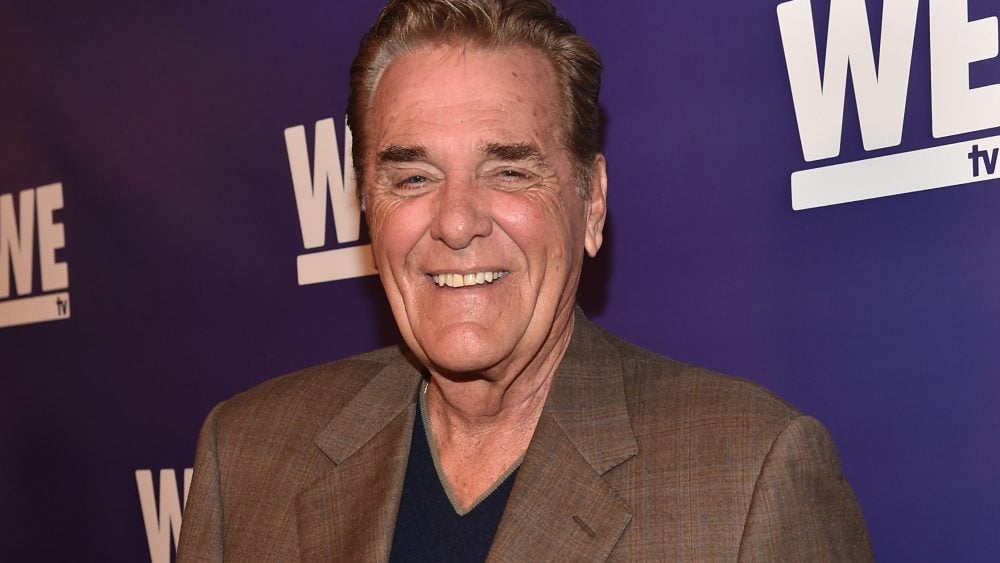 Chuck Woolery in his signature style as a game show host
