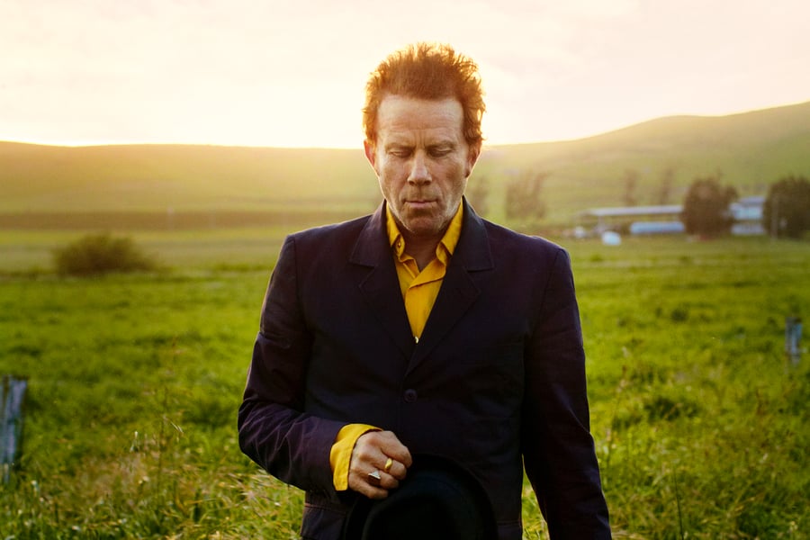 tom waits in green field