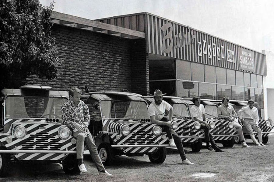 The Beach Boys posing with five matching Mini Mokes