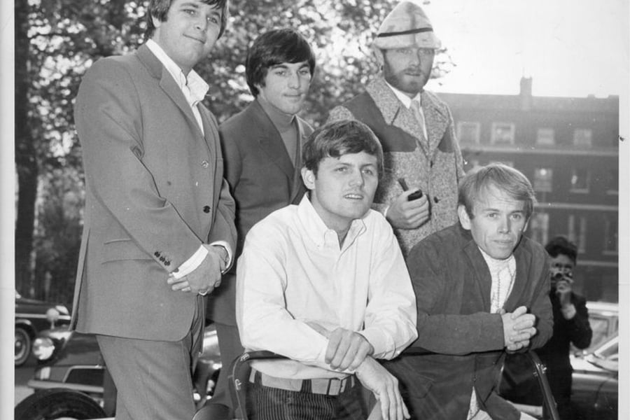 The Beach Boys pose for a portrait in a Mini Moke, 1966