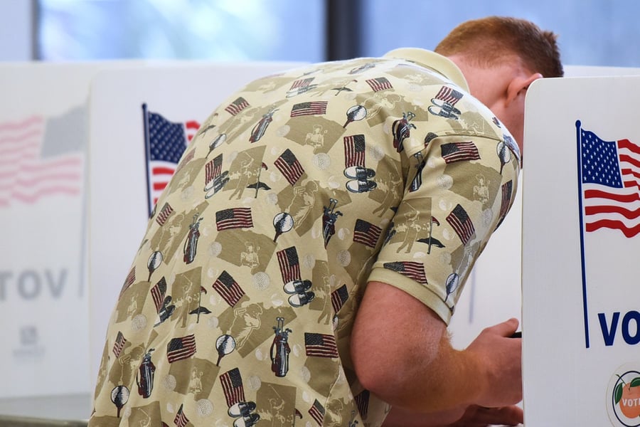 A voter fills out his ballot in Florida