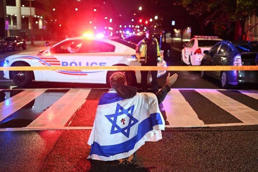 Metropolitan Police officers secure the area outside the Capital Jewish Museum following a shooting