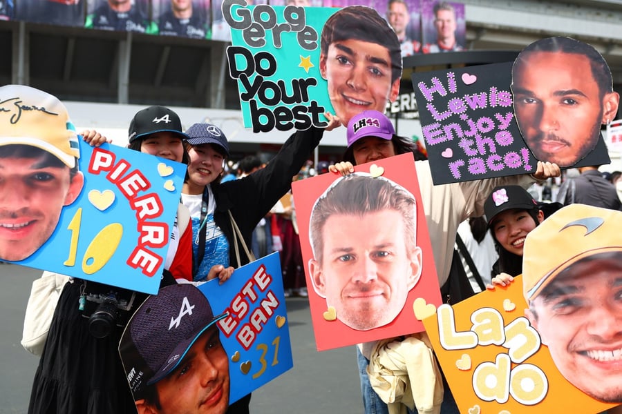 Fans hold posters supporting F1 drivers Pierre Gasly, Esteban Ocon, George Russell, Lewis Hamilton, Nico Hulkenberg, and Lando Norris at the F1 Grand Prix of Japan