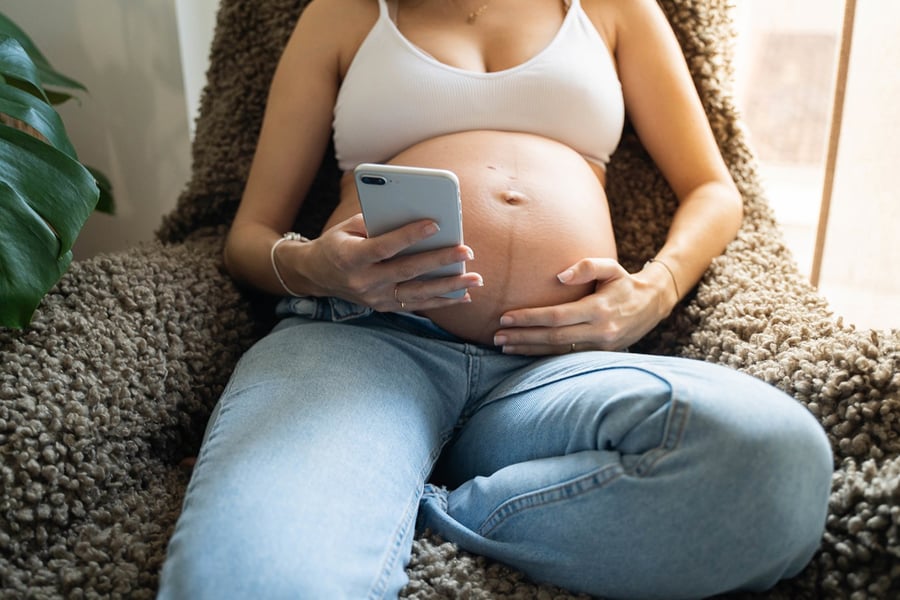 Pregnant woman on her phone
