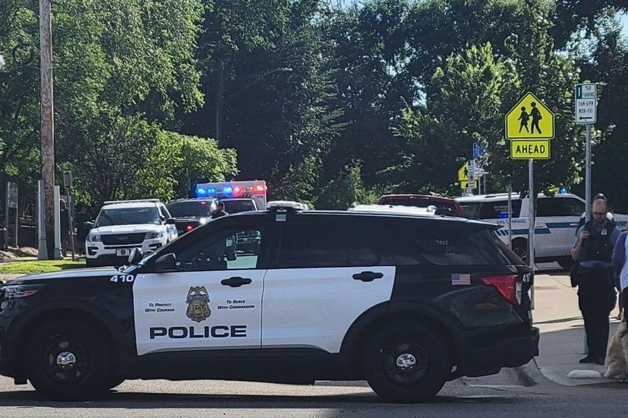 Police offers outside of the Annunciation Church’s school after a mass shooting