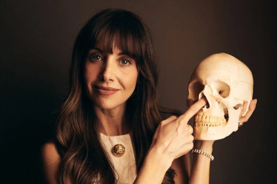 Alison Brie holding a skull
