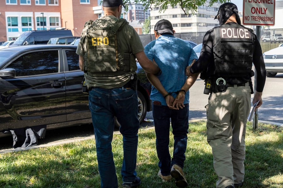 ICE agents detain an immigrant