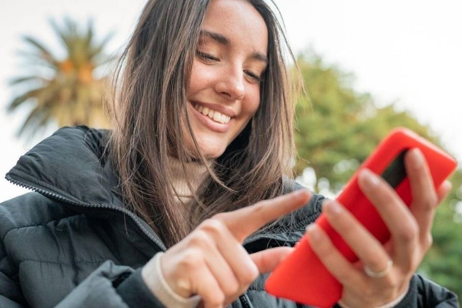 Woman scrolls on phone