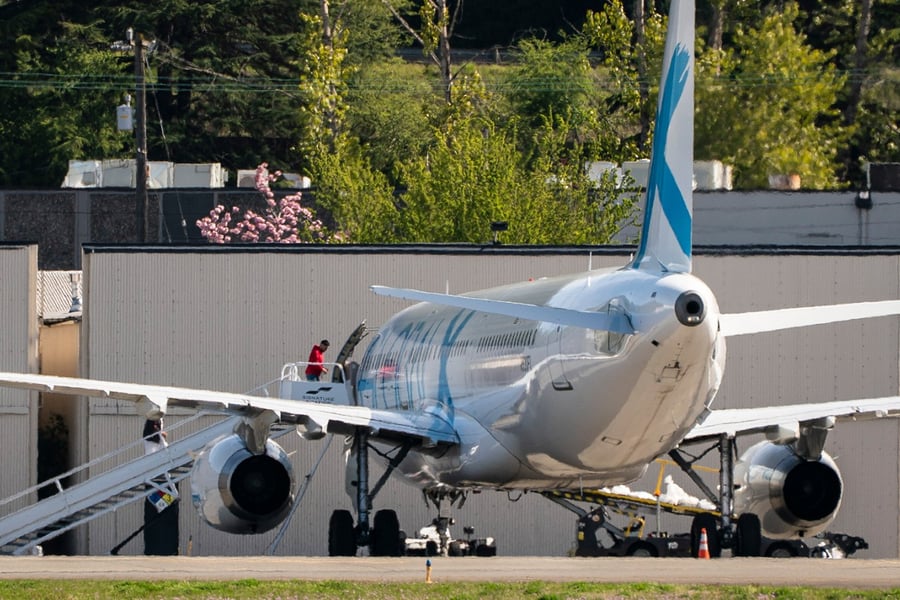 Detainees board a plane chartered by Immigration and Customs Enforcement (ICE) at King County International Airport in Seattle