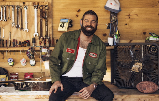 Jordan Davis posing in a shed smiling at the camera