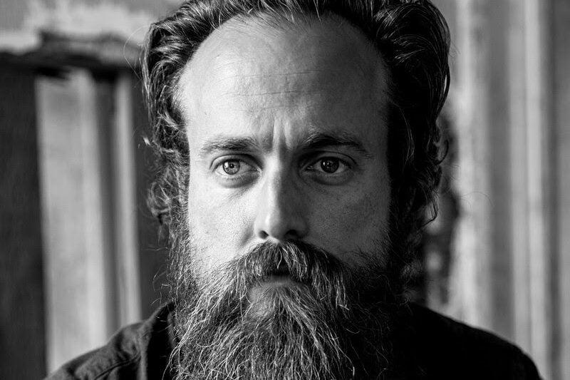 Iron & WIne's sam beam staring off camera in black and white