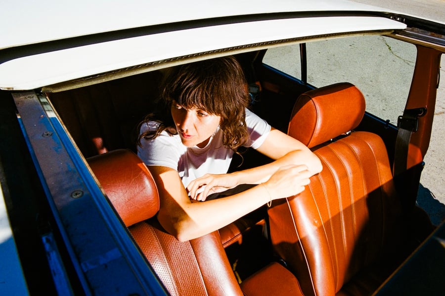 Courtney Barnett in the backseat of a car