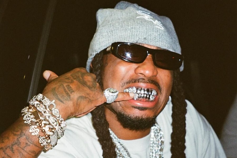 Quavo flashing his grills at the camera