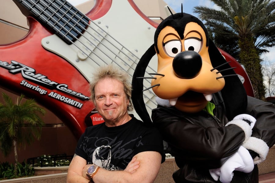 Aerosmith drummer Joey Kramer poses with Goofy