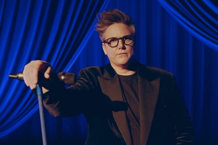 Hannah Gadsby posing with a microphone in hand
