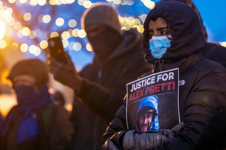 People mourn at a makeshift memorial in the area where 37-year-old Alex Pretti was shot dead by federal immigration agents earlier in the day in Minneapolis, Minnesota, on Jan. 24, 2026.