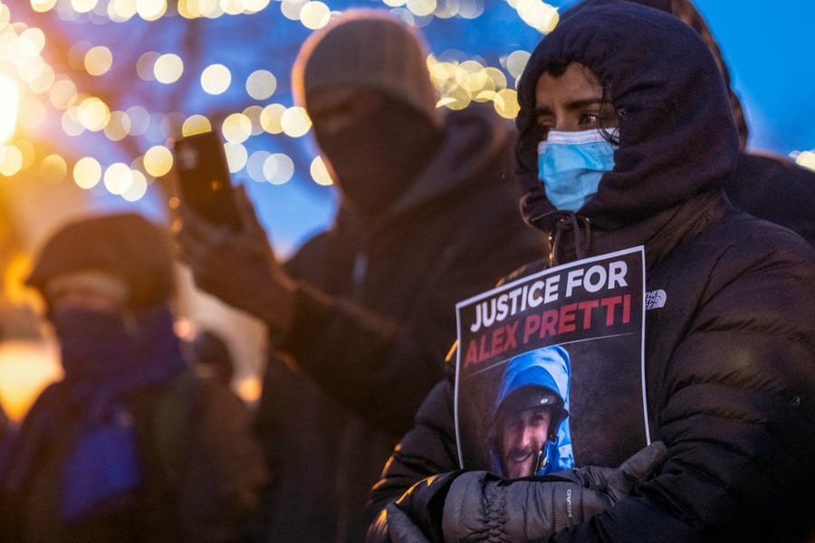 People mourn at a makeshift memorial in the area where 37-year-old Alex Pretti was shot dead by federal immigration agents earlier in the day in Minneapolis, Minnesota, on Jan. 24, 2026.