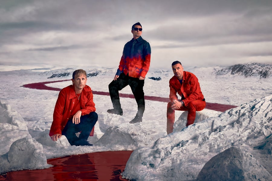 English rock band Muse in an icy landscape with a red river running through