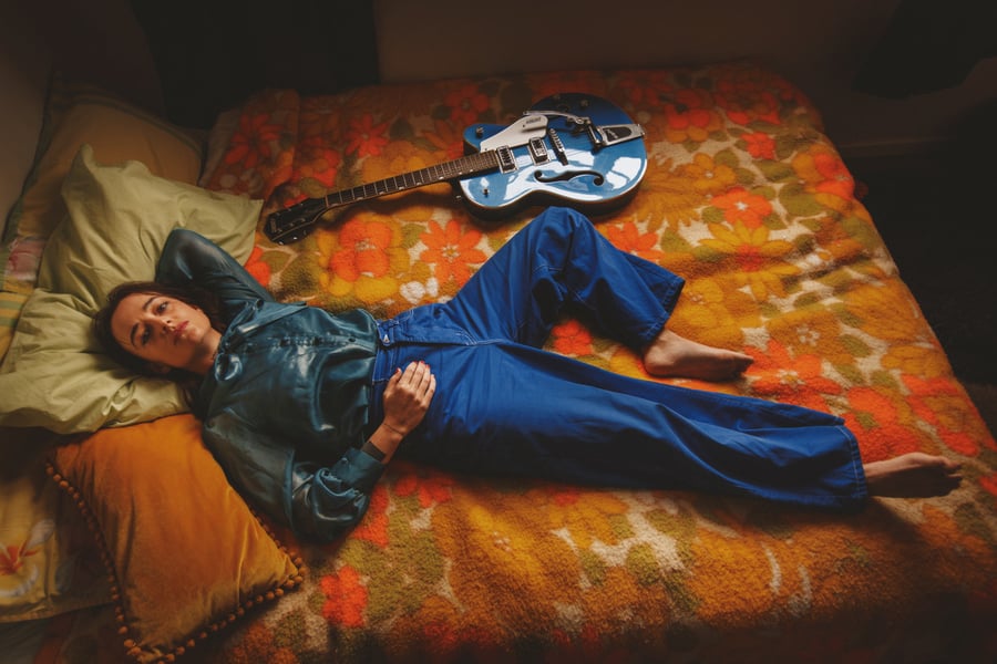 Jazmine Mary on a bed